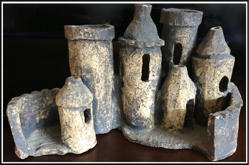 This is another "pot" in the shape of a castle. The tubes could be used as vases. 